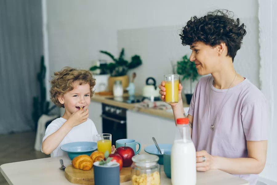 A parent and child sharing breakfast at a kitchen table